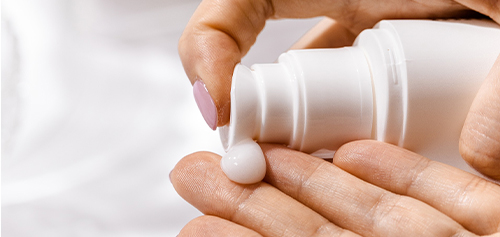woman's hand dispensing lotion