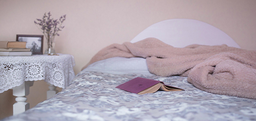 image of bed with book on it