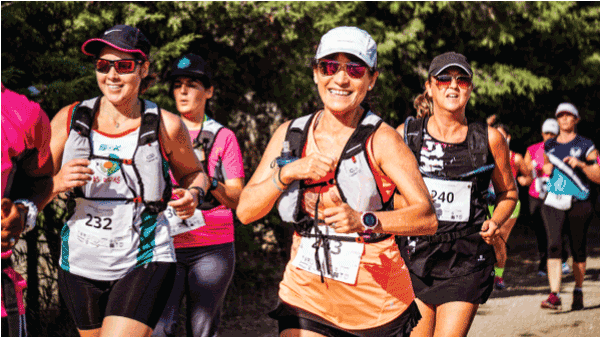 women smiling while running a marathon