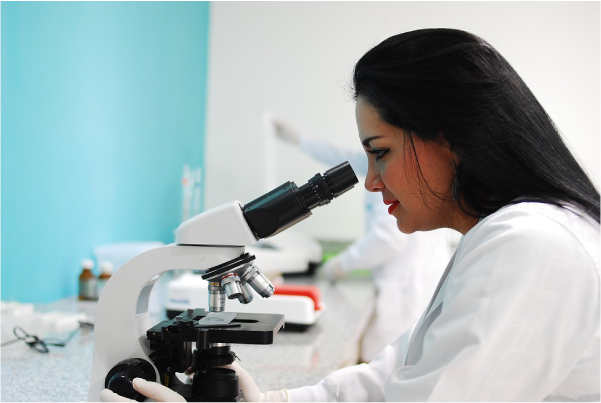 female scientist looking through a microscope